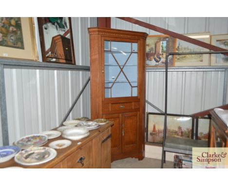 A 19th Century light oak chequer banded and inlaid free standing corner display cabinet, the upper shaped shelves enclosed by