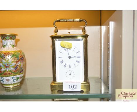 A brass cased carriage clock lacking key