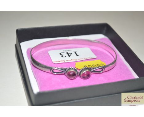 A 925 marked bangle with amethyst set stones
