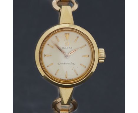Omega, a ladies yellow gold vintage manual wind Omega Seamaster wristwatch on a rolled gold bracelet, 19.83gm, currently work