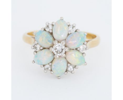 An 18ct yellow &amp; white gold flower design cluster ring set with six oval cabochon cut opals, measuring approx. 5.5mm x 4m