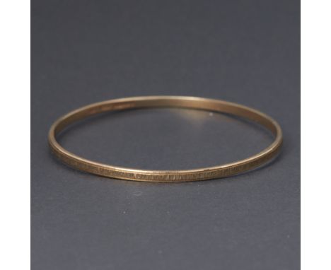 A 9ct yellow gold textured design bangle, inner diameter approx. 6.3cm, 11.32gm.