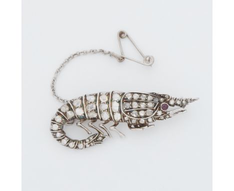 An Edwardian 'shrimp' design brooch set with old rough cut diamonds of varying shapes &amp; sizes and a cabochon cut ruby eye