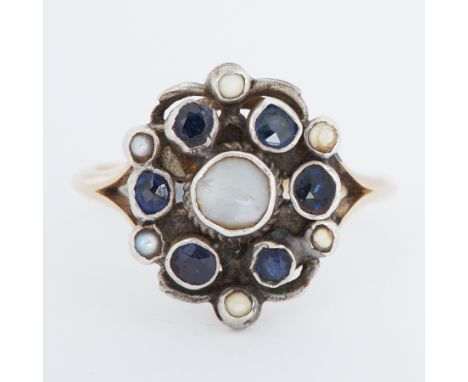 An Arts &amp; Crafts yellow gold &amp; white metal ring set with small round cut sapphires &amp; pearls, the head setting mea