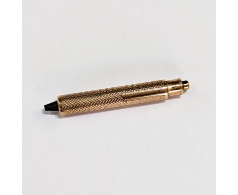 A 9ct gold engine turned engraved watch tool, length approx. 4.7cm, 7.87gm.