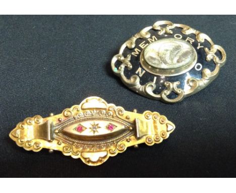 A Victorian black enamelled and and hair work mourning brooch, central oval aperture inset with a hair work and gold thread p
