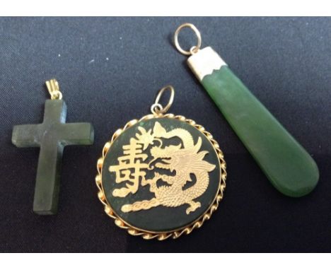 A Chinese green jade and gold coloured metal disc pendant, decorated with a dragon and character script;  another, elongated 