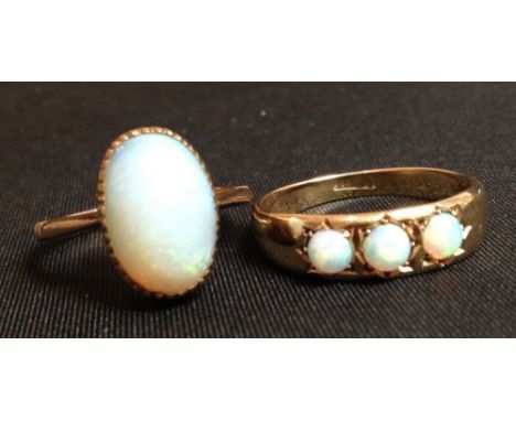 An Edwardian three stone opal ring, three uniform circular cabochon stones, 18ct yellow gold shank, size R, 3.8g gross; a sin