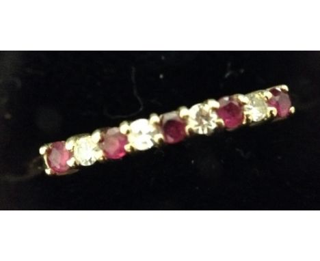 A diamond and ruby nine stone half eternity ring, set with five rubies and four diamonds, alternate set to open claw crest, 1