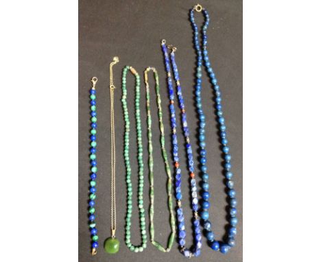 A lapis lazuli graduated globular bead necklace, spring clasp;  another, with faceted beads;  a lapis lazuli and malachite al