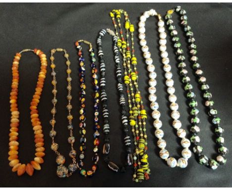 A Tri-colour marbleized glass bead necklace, the globular beads decorated in tones of ochre, yellow and blue on a cream/white