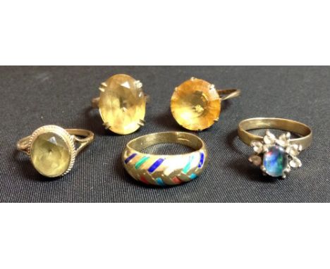 A large yellow citrine and 9ct gold single stone dress ring;  others;  a multi-colour enamelled yellow metal ring;  a simulat