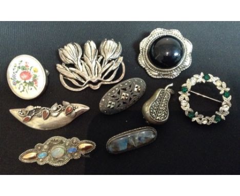 A stylish Scandinavian silver and amber floral brooch, inverted arched body with a cast floral motif and three tear drop ambe