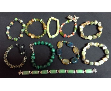 A Chinese stained green jade effect and white metal eight panel bracelet;  a jade and quartz encrusted woven multi-bead brace