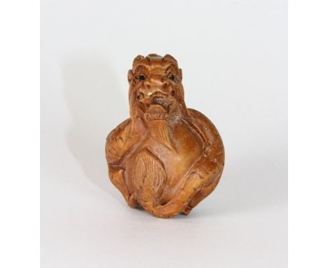 A signed carved wooden dragon netsuke with onyx eyes