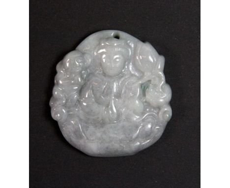 A mixed colour carved jade amulet of Guanyin holding a lotus with a child on her shoulder Dia 5cm