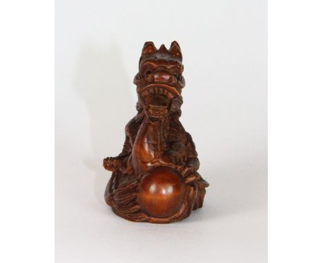A carved wooden dragon netsuke