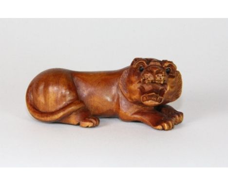 A signed carved wooden tiger Netsuke