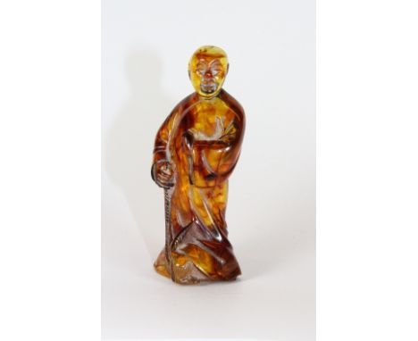 An interesting (amber?) figural netsuke H 7.5cm