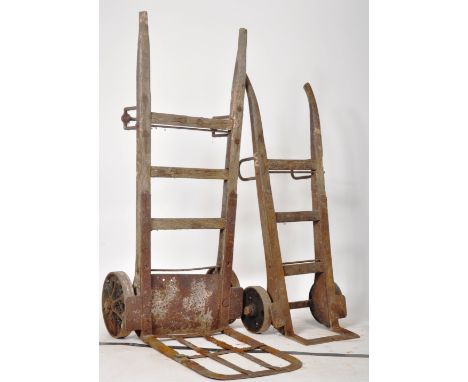 A pair of vintage 20th Century Industrial railway sack truck / trolley / display stand of oak and iron construction. Cast iro