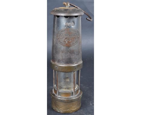 A vintage E. Thomas &amp; Williams No. 4 Brass Oil Lamp and hanging hook.&nbsp; A brass and steel Welsh miners safety with co