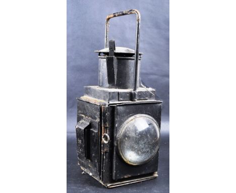 A large early 20th century Railway Lamp with twin bulls-eye lenses with a loose red (brake wagon) filter and intact oil burne