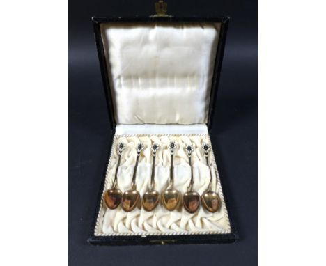 A set of six silver gilt and enamel coffee spoons, in case, marked '925 S. G. G.', total weight 1.48 toz, each spoon 9.5 cm l