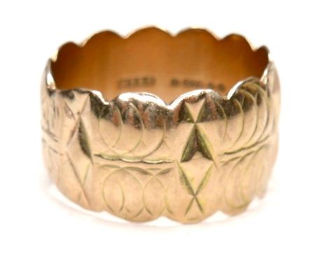 A 9ct gold wide ring with scalloped edges and engraved design, size Q/R, 12mm wide, 7.4g. 