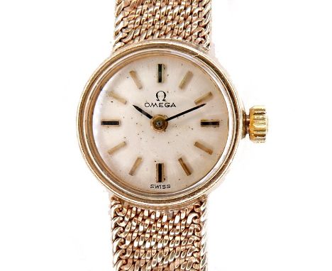 An Omega 9ct gold lady's wristwatch, circa 1965, model 711.5730, with circular champagne dial, gold baton numerals, black han