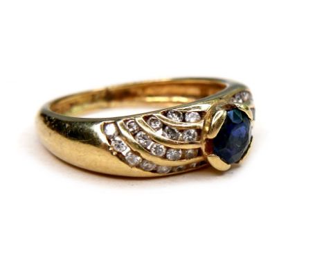 An 18ct gold sapphire and diamond ring, round cut sapphire 4mm diameter, flanked by four bands of small round cut diamonds, s