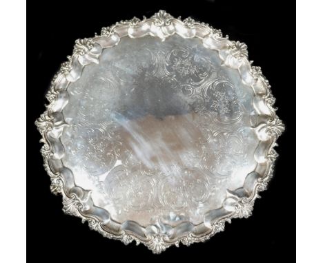 A Victorian silver salver tray, of circular Rococo form with Chippendale pie crust and C scroll rim, engraved foliate decorat