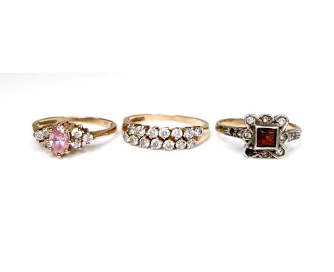 A group of three 9ct gold rings, the first set with a marquise cut pink stone with cubic zirconia to each shoulder, size M, 2