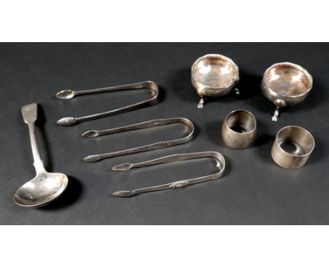 A group of Georgian and later silver items, comprising three pairs of sugar nips, two napkin rings, a sauce ladle, and a pair