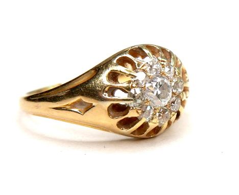 An unmarked gold diamond gypsy set cluster ring, the central brilliant cut stone, 3mm, 0.1ct, surrounded by eight smaller bri