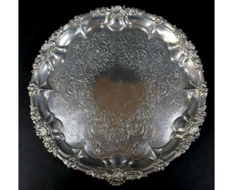 A Georgian silver waiter tray, of circular form with Chippendale pie crust edge, likely later chased and engraved decoration,