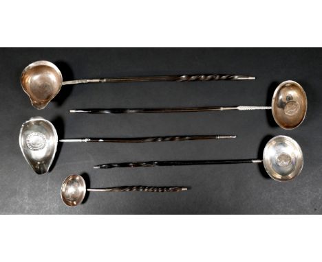 A group of five 18th and 19th century toddy ladles, most with baleen twist handles, one with inset Elizabeth I silver coin to