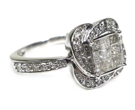 A 9ct white gold and diamond dress ring, set with nine princess cut diamonds each of approximately 2 by 2mm to the centre, su