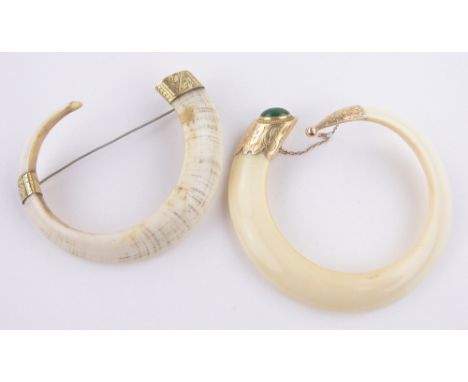 A Victorian Wild Boar tooth bangle,with engraved 15ct gold jade set mount, 10cm across and a Wild Boar tooth brooch with unma