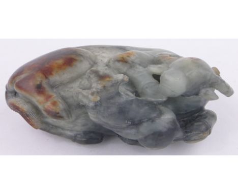 A Chinese Celadon jade reclining buffalo and calf,length 16cm.
