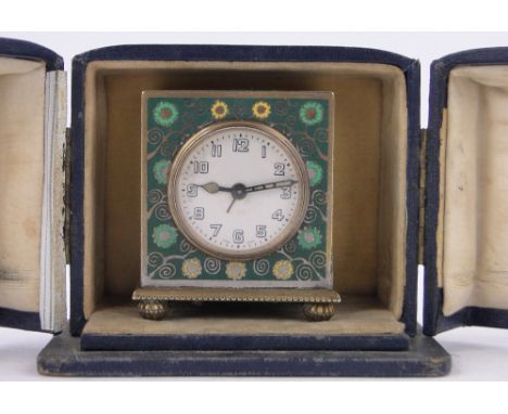 A Zenith brass and enamelled cased travelling alarm clock,height 6cm.