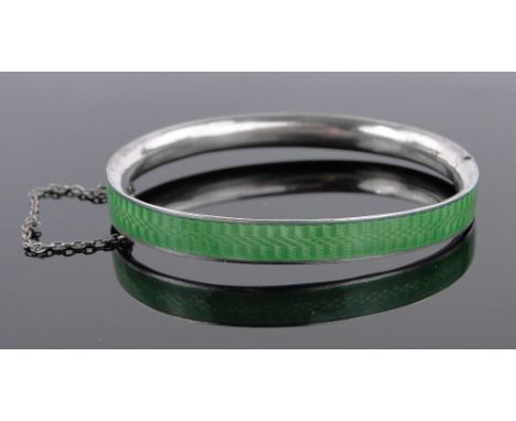 A silver and green enamel hinged bangle.