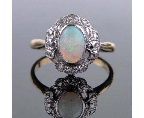 An 18ct gold and platinum natural opal and diamond cluster ring,setting height 14mm, size R.