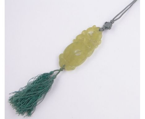 A Chinese relief carved and pierced jade pendant on silk cord,pendant length 70mm.