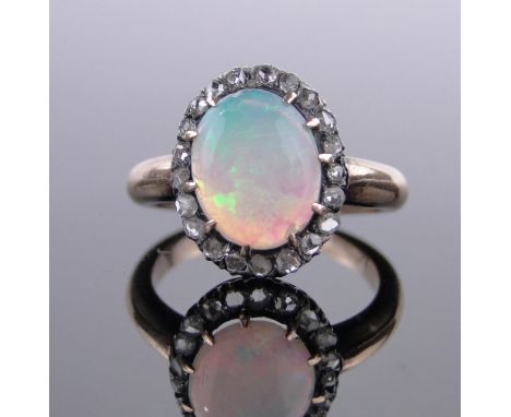 An 18ct gold opal and diamond cluster ring,setting height 15mm, size M.