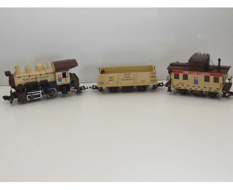 A group of unboxed ARISTOCRAFT G scale rolling stock comprising a locomotive, wagon and caboose from the 'Teddy Bear Railroad