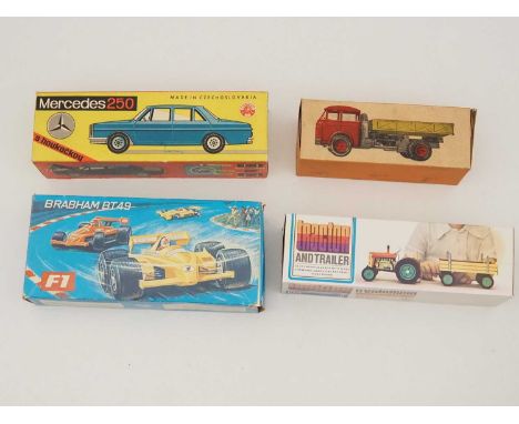 A group of vintage tinplate and plastic Czechoslovakian made toys comprising a tractor/trailer, a Formula 1 car, a Skoda lorr