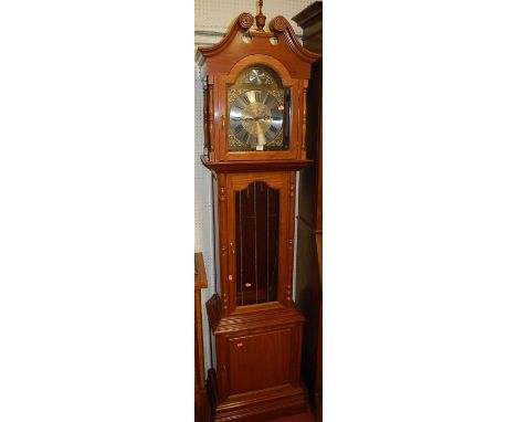 A contemporary cherry wood longcase clock, having arched silvered and brass dial, with three train movement, glazed trunk doo