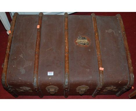 An early 20th century canvas, wooden, and metal bound cabin trunk, w.75cm