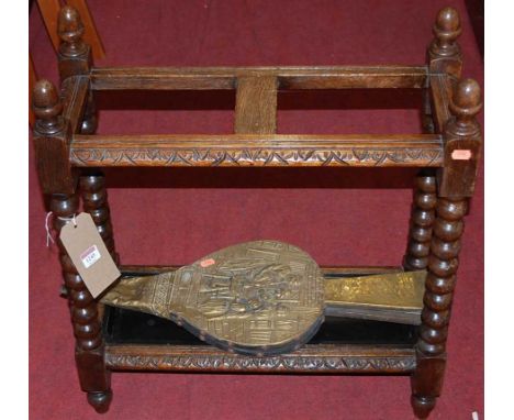 An early 20th century bobbin turned oak twin division stick stand, width 60.5cm, together with a pair of bellows (2)