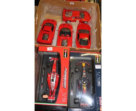 A Burago 1/18 scale Red Bull racing Formula One car; one other Ferrari; and a box containing four Maisto 1/18 Ferraris to inc